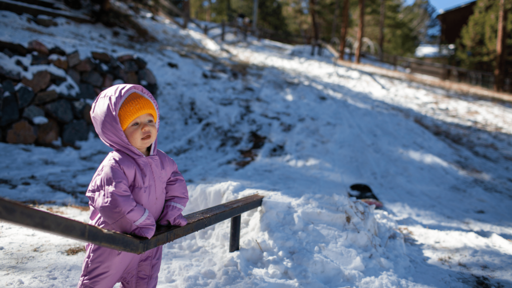 encouraging a small child to play outside in the snow