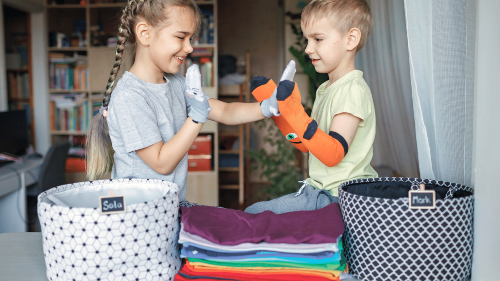 children organizing and folding laundry together