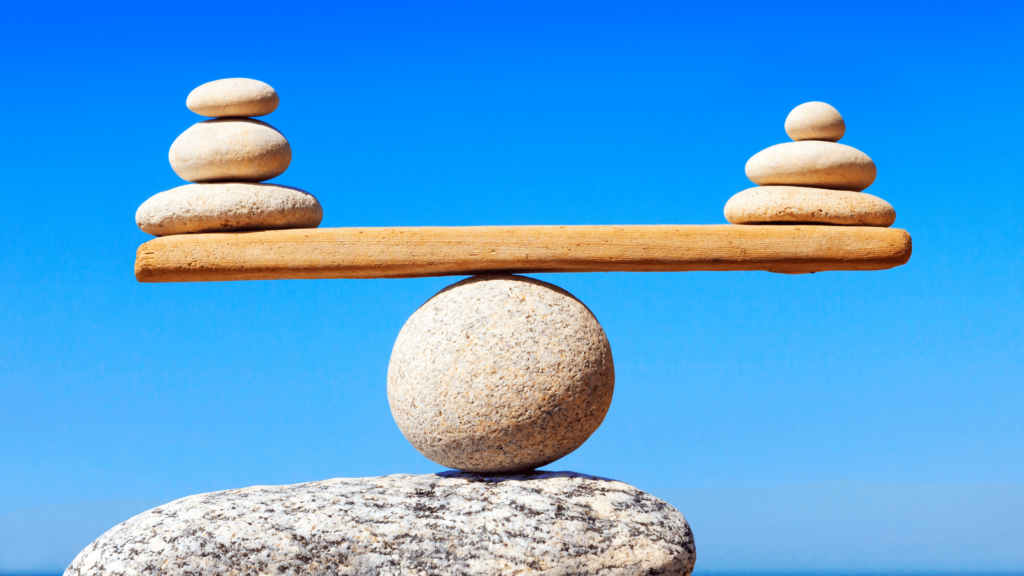 rocks balancing on a plank