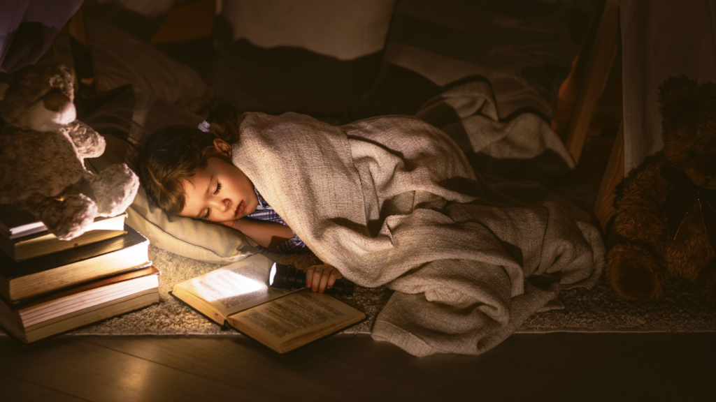 young child reading to go to sleep