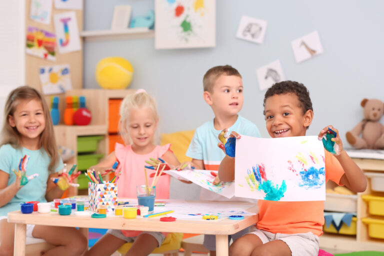 cute children painting in the pre-k classroom