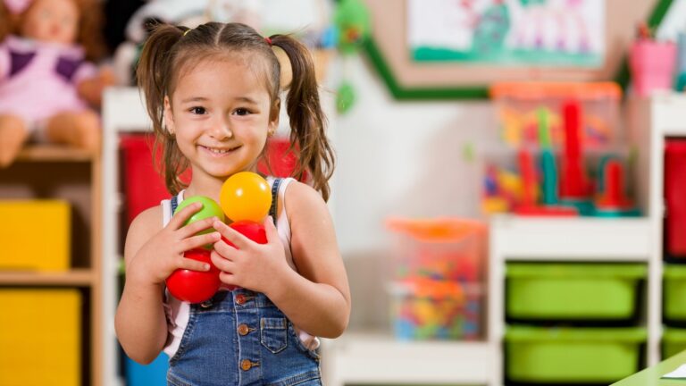 4 year old girl playing with colorful balls