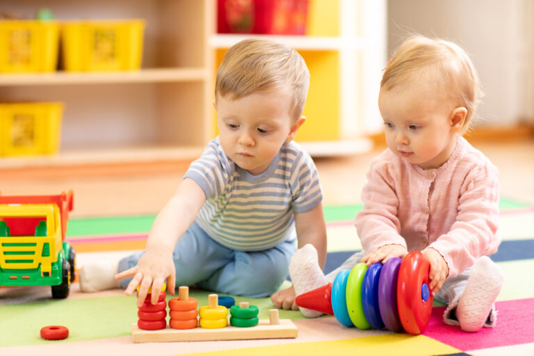 children playing on floor with educational toys at daycare