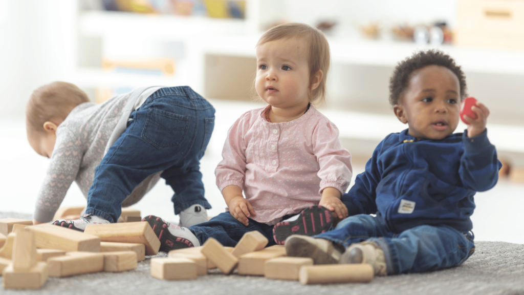 toddlers playing with wooden blocks and learning new things