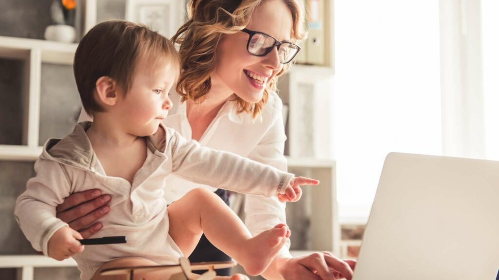 Smiling mother and child looking at a laptop