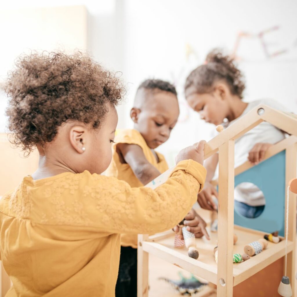 Diverse children playing with wooden toy