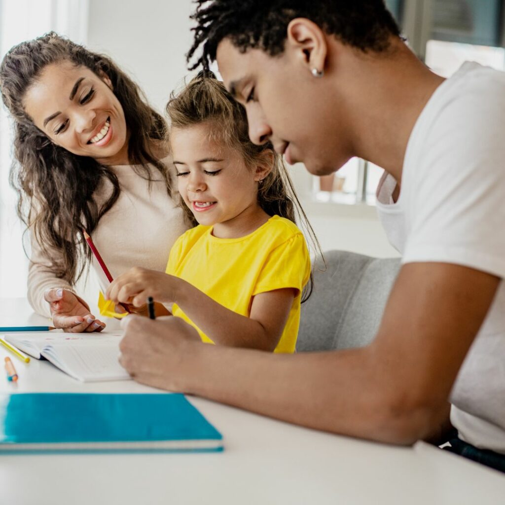 Parents coloring with a young girl. 