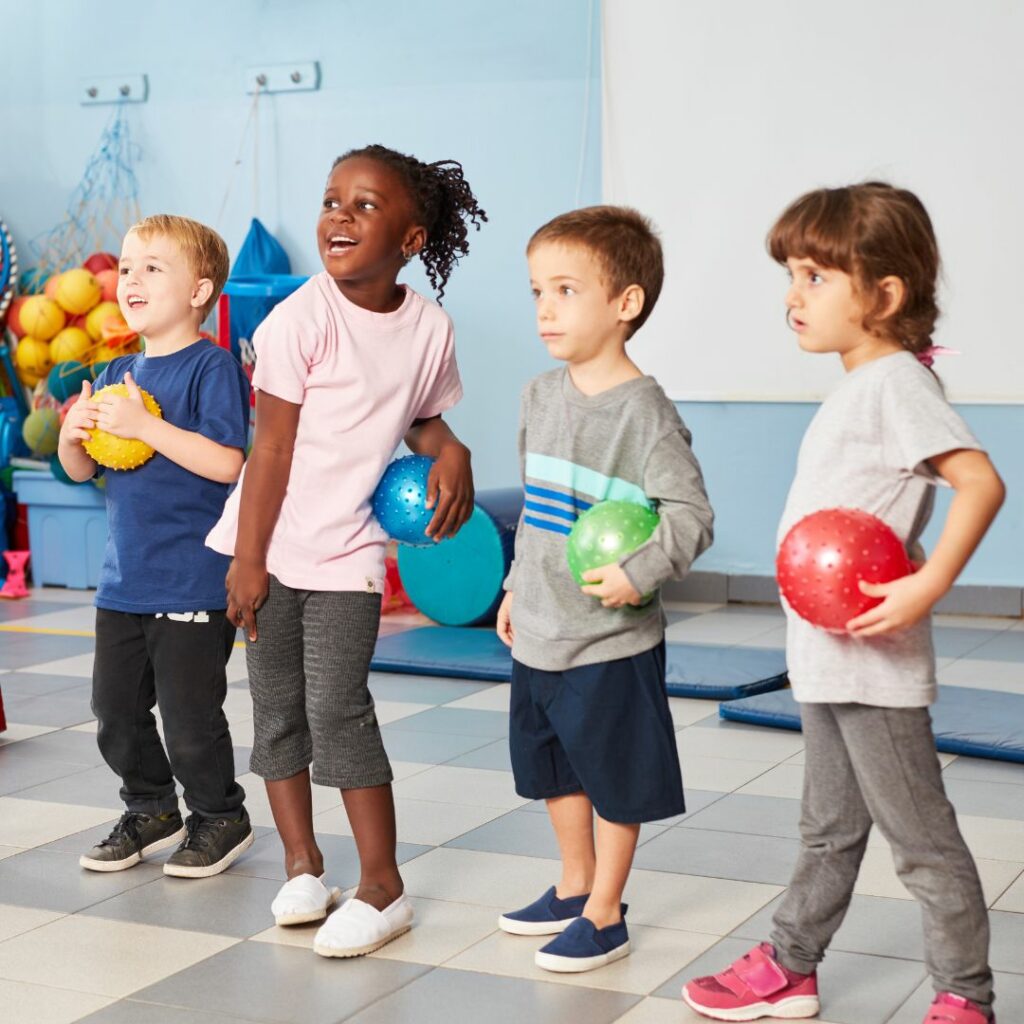 kids in a row holding a ball