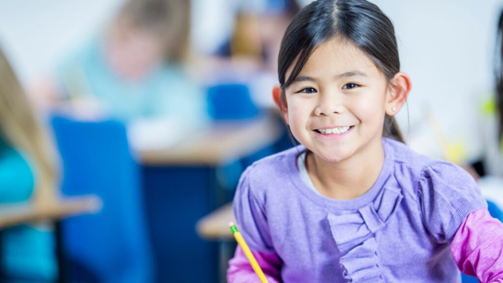 happy kid with a pencil